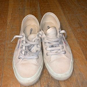 Worn out white canvas sneakers